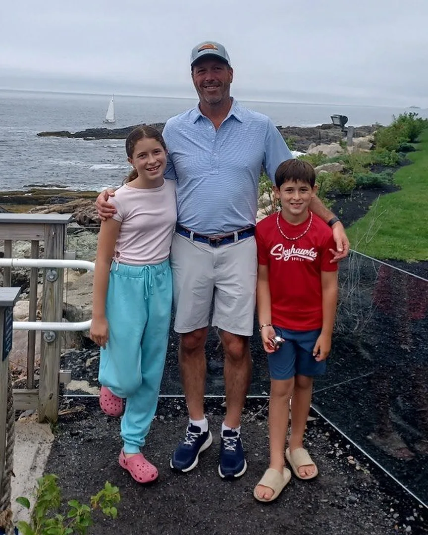 Greg, founder of Spirantix, with his two children by the sea